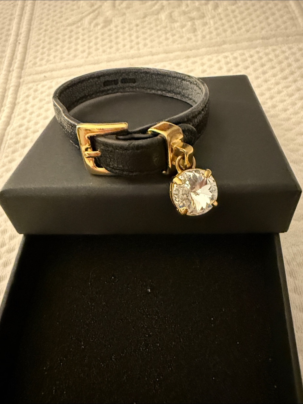 Miu Miu Black Leather Bracelet with Gold Hardware and Crystal Charm